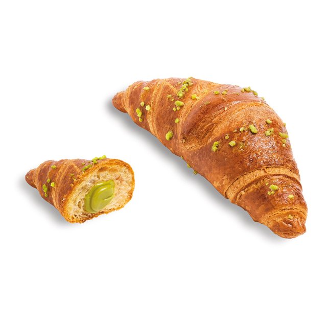 Goldenes Croissant mit gehackten Pistazien, eine Hälfte zeigt cremige grüne Pistazienfüllung.