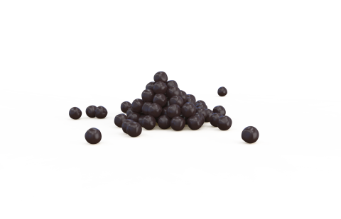 Kleiner Haufen dunkelvioletter runder Pellets auf weißem Hintergrund, einige verstreut daneben.